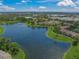 Scenic aerial view of condo community nestled alongside a serene lake at 4037 Crockers Lake Blvd # 17, Sarasota, FL 34238