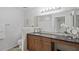 Bathroom features a large vanity, granite countertops, and large mirror with Hollywood lighting at 4037 Crockers Lake Blvd # 17, Sarasota, FL 34238