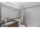 Bathroom featuring a vanity with granite counter, framed mirror, and shower-tub combo at 4037 Crockers Lake Blvd # 17, Sarasota, FL 34238