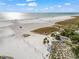 Expansive white sand beach with clear blue water, palm trees, and a volleyball net at 4037 Crockers Lake Blvd # 17, Sarasota, FL 34238