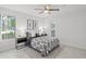 Bright bedroom has a ceiling fan, natural light, and attractive blue and white patterned bedding at 4037 Crockers Lake Blvd # 17, Sarasota, FL 34238