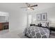 Well-lit bedroom features a ceiling fan, tiled flooring and a view into the bathroom at 4037 Crockers Lake Blvd # 17, Sarasota, FL 34238