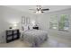 Well-lit bedroom with tile floors, a ceiling fan, and a view of the outdoors at 4037 Crockers Lake Blvd # 17, Sarasota, FL 34238