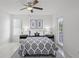Airy bedroom with ceiling fan, ample sunlight, and stylish blue and white patterned bedding at 4037 Crockers Lake Blvd # 17, Sarasota, FL 34238