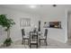 Inviting dining area with contemporary table set, decorative tree art and a pass-through to the kitchen at 4037 Crockers Lake Blvd # 17, Sarasota, FL 34238