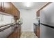 Bright kitchen features stainless steel refrigerator and sink, dark granite countertops and tiled backsplash at 4037 Crockers Lake Blvd # 17, Sarasota, FL 34238