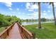 Picturesque lake view with a wooden boardwalk at 4037 Crockers Lake Blvd # 17, Sarasota, FL 34238