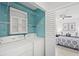 Laundry room with a washer, dryer, storage shelves, and an open view into the bedroom at 4037 Crockers Lake Blvd # 17, Sarasota, FL 34238