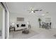 Inviting living room with natural light, tile flooring, ceiling fan, and a dining area at 4037 Crockers Lake Blvd # 17, Sarasota, FL 34238