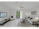 Comfortable living room featuring tile floors, neutral decor, and sliding glass doors to the patio at 4037 Crockers Lake Blvd # 17, Sarasota, FL 34238