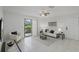 Bright living room with tile floors, contemporary furniture, and sliding door access to patio at 4037 Crockers Lake Blvd # 17, Sarasota, FL 34238