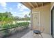 Covered patio with patio furniture and a view of lush landscaping and clear blue skies at 4037 Crockers Lake Blvd # 17, Sarasota, FL 34238