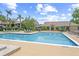 Inviting community pool and clubhouse with lounge chairs for residents at 4037 Crockers Lake Blvd # 17, Sarasota, FL 34238