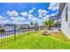 Well-maintained backyard with a fire pit, direct canal access and lush landscaping surrounded by a metal fence at 4312 Vasco St, Punta Gorda, FL 33950