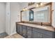 Spacious bathroom with dual sinks, large framed mirror, modern vanity and tile flooring at 4312 Vasco St, Punta Gorda, FL 33950