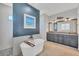 Modern bathroom boasts soaking tub, dual sinks with gray cabinets, and accent wall with picture at 4312 Vasco St, Punta Gorda, FL 33950