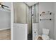 Bright bathroom featuring a glass shower with a black pebble floor and a two-shelf storage unit at 4312 Vasco St, Punta Gorda, FL 33950