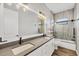 This bathroom includes a double sink vanity with a large mirror, as well as a shower and tub combination at 4312 Vasco St, Punta Gorda, FL 33950