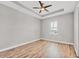 The bedroom is spacious and has wood floors, a ceiling fan, and a window at 4312 Vasco St, Punta Gorda, FL 33950