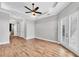 Spacious bedroom features hardwood floors, tray ceiling with ceiling fan, and french doors to the outside at 4312 Vasco St, Punta Gorda, FL 33950
