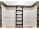 Custom walk-in closet featuring custom shelves and hanging rods for optimal organization at 4312 Vasco St, Punta Gorda, FL 33950