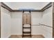 Walk-in closet with custom shelves, hanging rods, and wooden floor at 4312 Vasco St, Punta Gorda, FL 33950