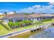 Exterior view of a waterfront home with a private dock, screened-in lanai, and lush landscaping in a fenced yard at 4312 Vasco St, Punta Gorda, FL 33950