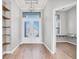 Elegant foyer with wood floors, a decorative chandelier, and transom window at 4312 Vasco St, Punta Gorda, FL 33950