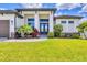 Close-up of front entrance featuring an elegant door, decorative plants, and a well-maintained lawn at 4312 Vasco St, Punta Gorda, FL 33950