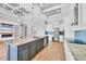 Modern kitchen features an island with seating, stainless steel appliances, and built-in shelves at 4312 Vasco St, Punta Gorda, FL 33950