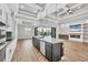 Modern kitchen features an island with seating, stainless steel appliances, and sliding doors to the patio at 4312 Vasco St, Punta Gorda, FL 33950