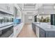 Modern kitchen features an island with seating, stainless steel appliances, and sliding doors to the patio at 4312 Vasco St, Punta Gorda, FL 33950