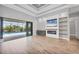 Bright living room featuring wood floors, coffered ceilings, a modern fireplace, and sliding glass doors to the lanai at 4312 Vasco St, Punta Gorda, FL 33950