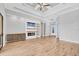 Spacious living room with wood floors, a ceiling fan, coffered ceilings and a modern fireplace feature wall at 4312 Vasco St, Punta Gorda, FL 33950