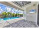 A spacious screened-in patio with a large pool, jacuzzi, ceiling fan and outdoor television at 4312 Vasco St, Punta Gorda, FL 33950