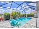 Relaxing screened-in pool with waterfall, jacuzzi and chairs next to tropical landscaping at 4312 Vasco St, Punta Gorda, FL 33950