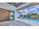 Screened-in patio with a pool, waterfall, jacuzzi, ceiling fan and sliding glass door entry at 4312 Vasco St, Punta Gorda, FL 33950