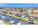 Aerial shot of a home with a screened-in lanai, canal access, a boat and small boats docked at its waterfront at 4312 Vasco St, Punta Gorda, FL 33950