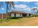 Well-maintained backyard with lush green lawn and mature tropical landscaping and screened-in porch at 4471 Atwood Cay Cir # 13, Sarasota, FL 34233