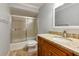This bathroom features a decorative vanity with a stone countertop, and a shower and tub combo with sliding glass doors at 4471 Atwood Cay Cir # 13, Sarasota, FL 34233