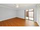 This bedroom features wood floors, a ceiling fan, sliding glass doors and a closet with bi-fold doors at 4471 Atwood Cay Cir # 13, Sarasota, FL 34233
