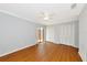This bedroom has wood floors, a ceiling fan, and multiple closets at 4471 Atwood Cay Cir # 13, Sarasota, FL 34233