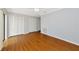 This bedroom features wood floors, a ceiling fan and multiple closets at 4471 Atwood Cay Cir # 13, Sarasota, FL 34233