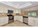 Well-lit kitchen features stainless steel appliances and granite countertops at 4471 Atwood Cay Cir # 13, Sarasota, FL 34233