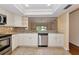 Bright kitchen features stainless steel appliances, granite countertops, and stylish backsplash at 4471 Atwood Cay Cir # 13, Sarasota, FL 34233