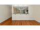 Living room with wood flooring and a pass-through to the kitchen at 4471 Atwood Cay Cir # 13, Sarasota, FL 34233