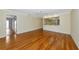 Spacious living room with fan, wood floors, and view to kitchen at 4471 Atwood Cay Cir # 13, Sarasota, FL 34233