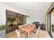 Outdoor patio has a dining table, grill, ceiling fan and access to both the kitchen and living room at 4471 Atwood Cay Cir # 13, Sarasota, FL 34233