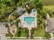 Aerial view of the community pool, playground, and amenities surrounded by lush landscaping and green spaces at 4542 Cedar Brush Ter, Sarasota, FL 34243
