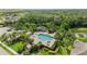 Aerial view of community pool and outdoor kitchen surrounded by lush landscaping and mature trees at 4542 Cedar Brush Ter, Sarasota, FL 34243